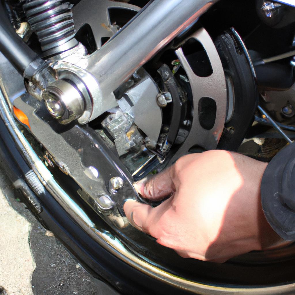 Person examining motorcycle braking system